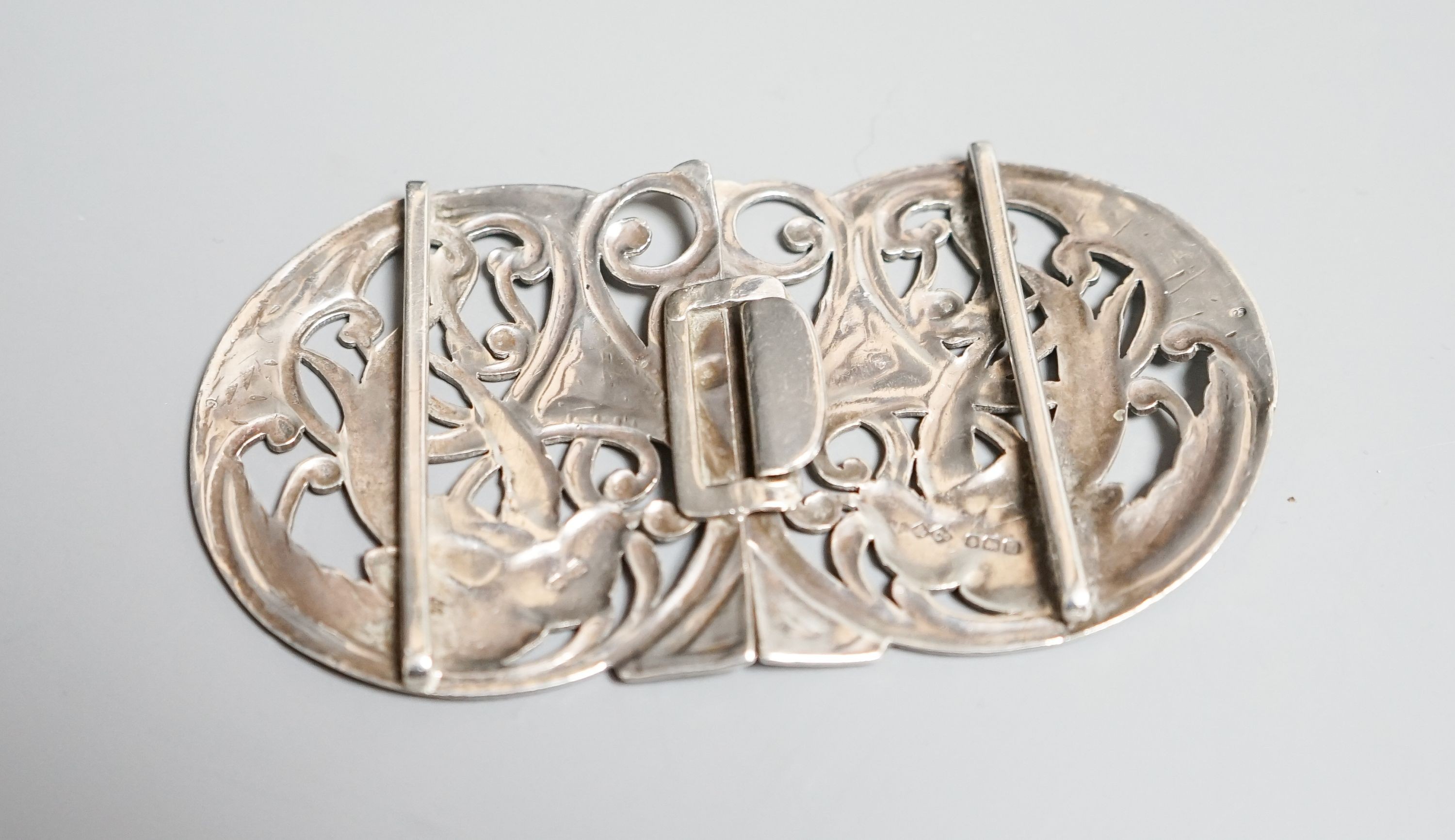 A George V Art Nouveau Liberty & Co pierced silver belt buckle, Birmingham, 1911, overall width 10.9cm.